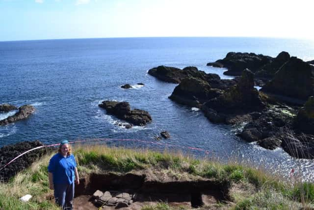 Cathy MacIver, archaeologist, of AOC Archaeology (red hair) pictured by a hearth discovered by the team, where animal bones were also found. Picture: Alison Campsie/TSLP