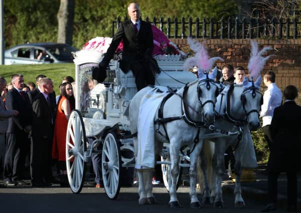 Mourners walk behind a horse-drawn hearse carrying the coffin of 15-year-old Paige Doherty. Picture: PA