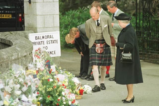 The Royal Family inspect flowers laid at the gates to Balmoral Castle in memory of Diana Princess of Wales. Picture: Allan Milligan