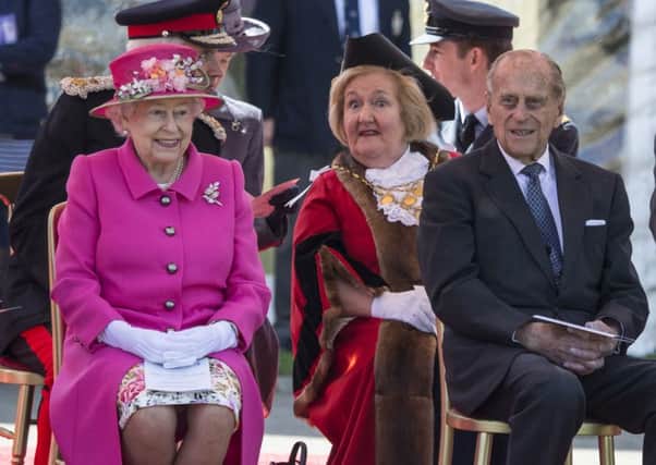The Queen, accompanied by the Duke of Edinburgh, opens a bandstand in Windsor yesterday. Picture: PA