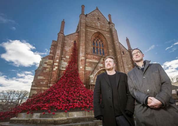 Artist Paul Cummins (left) and installation designer Tom Piper with their Weeping Window sculpture in Orkney. Picture :PA