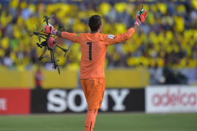 Uruguayan goalie Fernando Muslera picks up a drone that fell on the field during their Russia 2018 FIFA World Cup South American Qualifiers football match against Ecuador, in Quito. Picture: AFP/Getty Images