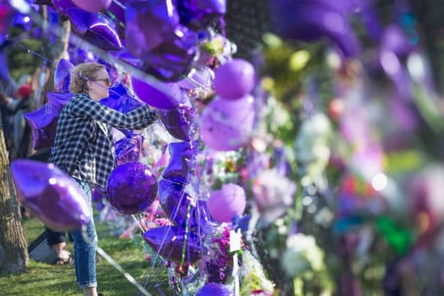 A music fan visits a memorial created outside Paisley Park, the home and studio of Prince. Picture: Getty Images