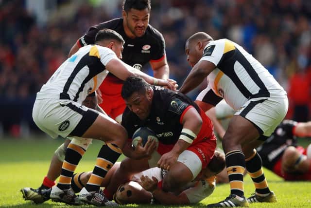 Saracens Mako Vunipola is tackled by Wasps Jimmy Gopperth as he tries to burst through. Picture: PA