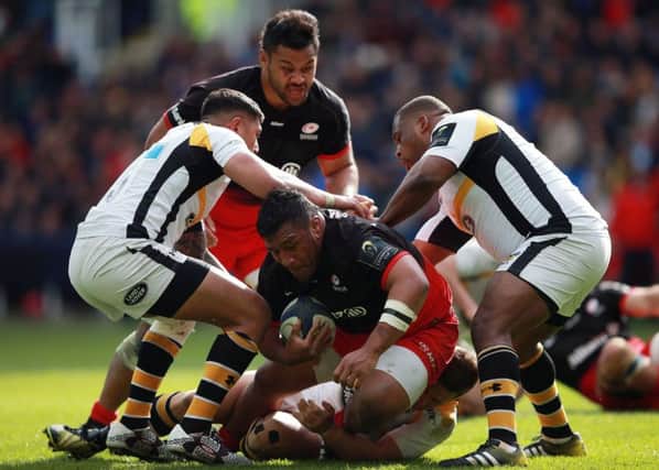 Saracens Mako Vunipola is tackled by Wasps Jimmy Gopperth as he tries to burst through. Picture: PA