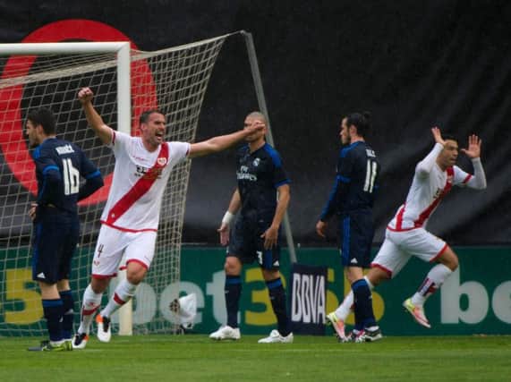 Rayo Vallecano's ex-Celtic forward Miku, right, celebrates his goal against Real Madrid. Picture: AFP/Getty Images