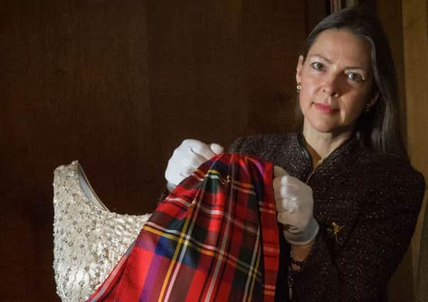 The evening dress and Royal Stewart tartan sash designed by Normal Hartnell, worn by The Queen to the Gillie's Ball in 1971. Picture: Steven Scott Taylor