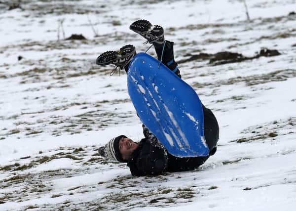 A man sledges in a field near the A93 as the snow gates on the A93 at Spittal of Glenshee are closed due to snow. Picture: PA