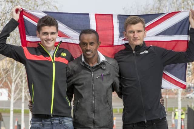 Tsegai Tewelde is flanked by Scottish brothers Callum, left, and Derek Hawkins as they celebrate their inclusion in the Great Britain Olympic marathon team. Picture: Jeff Holmes