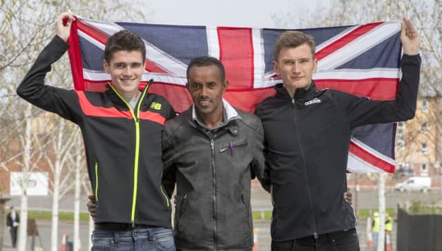 Tsegai Tewelde is flanked by Scottish brothers Callum, left, and Derek Hawkins as they celebrate their inclusion in the Great Britain Olympic marathon team. Picture: Jeff Holmes
