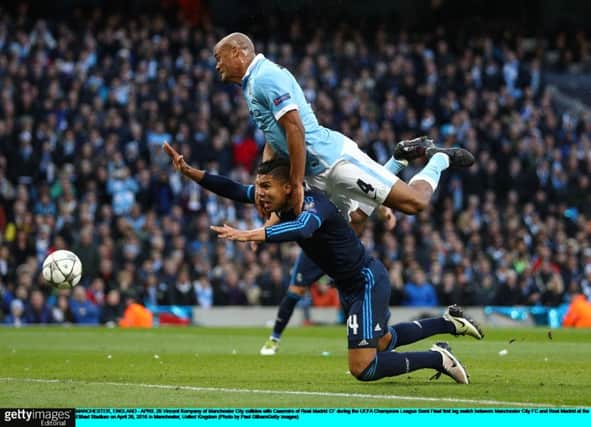 Real Madrid midfielder Casemiro succumbs to the challenge of Manchester City captain Vincent Kompany. Picture: Paul Gilham/Getty