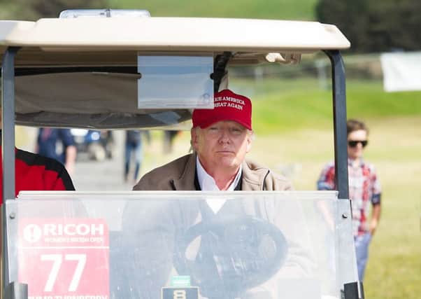 Donald Trump in a golf buggy on his Turnberry course