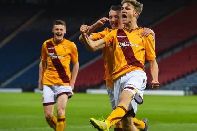 Motherwells David Ferguson, right, celebrates after he scores his sides third goal. Picture: SNS