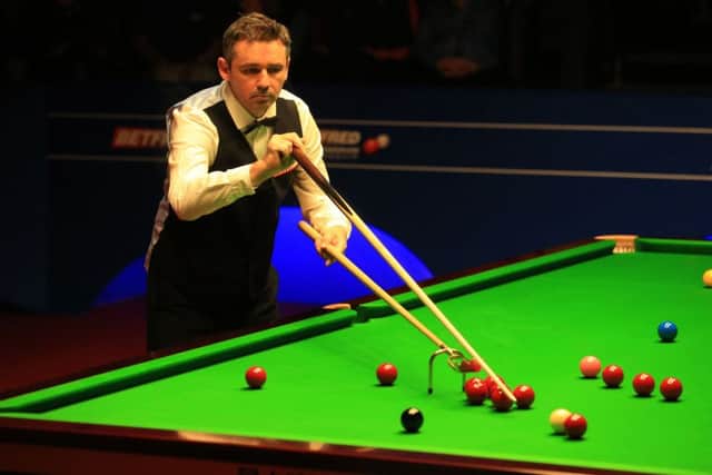 Mark Selby celebrates his 13-8 victory over Kyren Wilson, who had the consolation of a 143 break. Picture: PA
