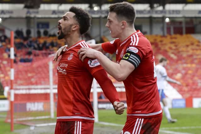 Shay Logan, left, has become the latest fan favourite at Pittodrie to sign a new deal. Picture: SNS