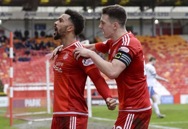 Shay Logan, left, has become the latest fan favourite at Pittodrie to sign a new deal. Picture: SNS