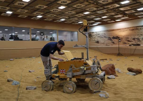 Major Tim Peake has taken control of the newest Mars rover Bridget  from space, driving it around a UK hangar. Picture: AFP/Getty Images