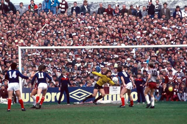 Dundee's Albert Kidd (left, No 14) watches as Hearts goalkeeper Henry Smith scrambles in vain to reach his shot. Picture: SNS