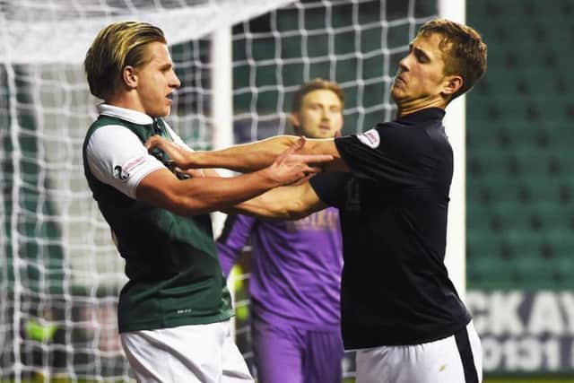 While Hibernians Jason Cummings and Falkirks Will Vaulks get up close and personal. Picture: Craig Williamson