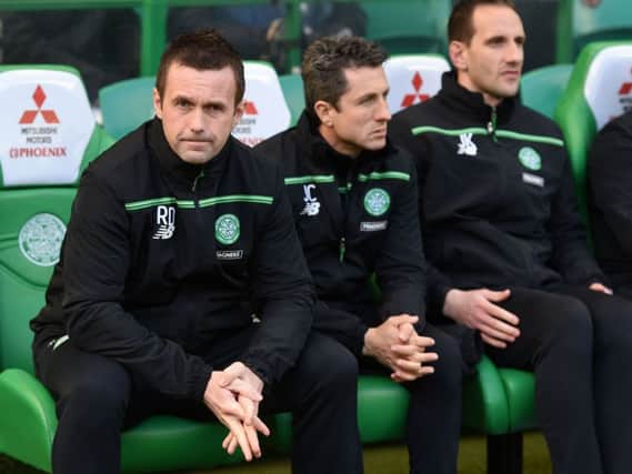 Celtic boss Ronny Deila believes John Collins, centre, and John Kennedy, right, could step up to the roles of manager and assistant manager when he leaves at the end of the season. Picture: SNS