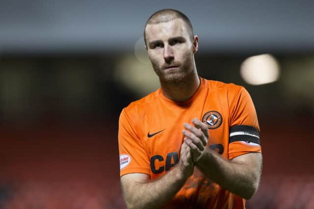 Dundee United's Sean Dillon applauds the home support and says they are right to protest. Picture: Kenny Smith/SNS