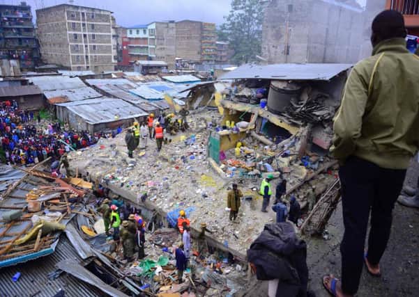 Kenyan emergency personnel look for survivors under the rubble Picture: AFP PHOTO / JOHN MUCHUCHA