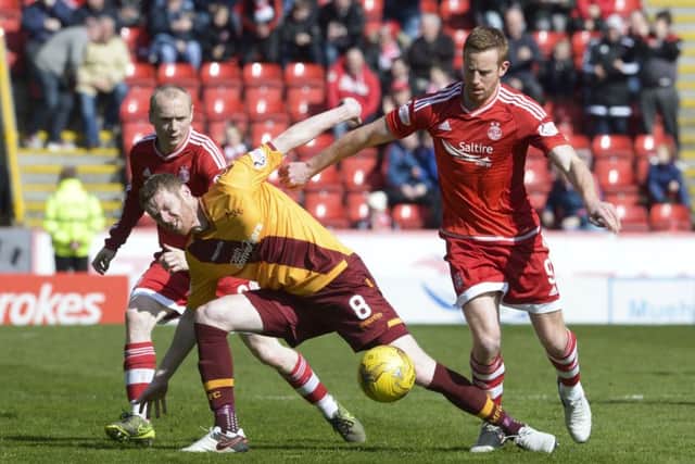 Motherwell's Stephen Pearson battles with Aberdeen's Adam Rooney Picture: SNS Group