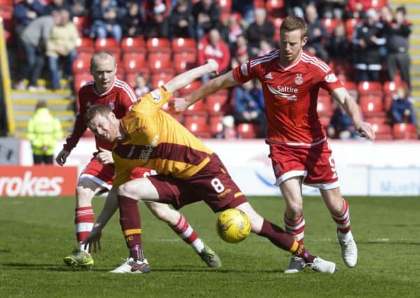 Motherwell's Stephen Pearson battles with Aberdeen's Adam Rooney Picture: SNS Group