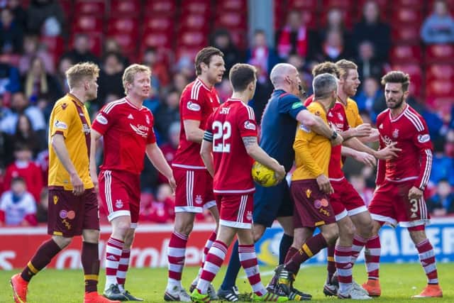 Motherwell captain Keith Lasley argues with Aberdeen's Graeme Shinnie Picture: SNS Group