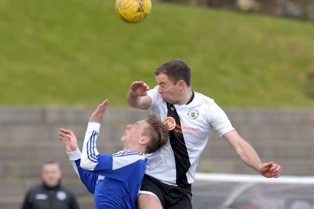 Edinburgh City's Douglas Gair outjumps Cove Rangers' Blair Yule.
Picture: Jane Barlow