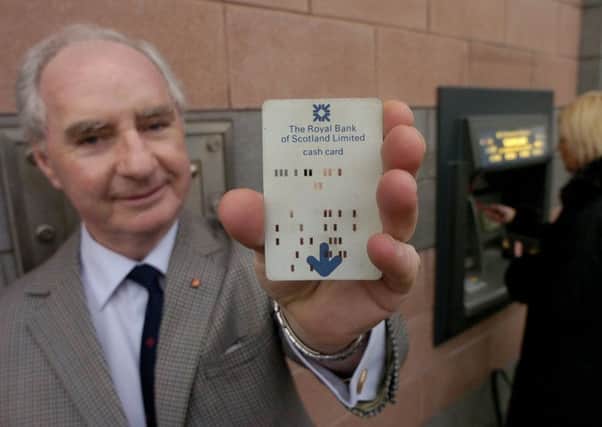 PIN inventor James Goodfellow with his own original bank card from the 1960s. Picture: Colin Mearns