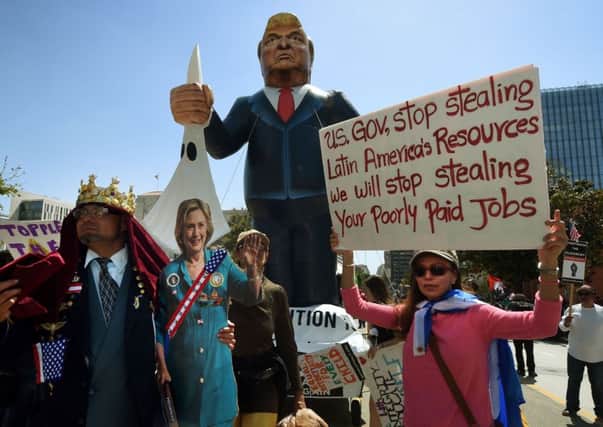 Members of the 'Full Rights for Immigrants Coalition' displayed a giant effigy of US Republican Party presidential hopeful Donald Trump and Democratic candidate Hillary Clinton as part of their May Day protest in Los Angeles yesterday. Picture: Mark Ralston/AFP/Getty Images