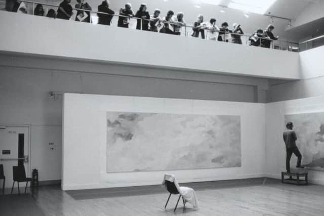 Jon Schueler painting at Talbot Rice in 1981, with gallery visitors on the balcony. Picture: Archie I. McLellan