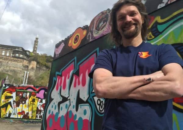 Artist Chris Rutterford with the New Street graffiti. Picture: Contributed