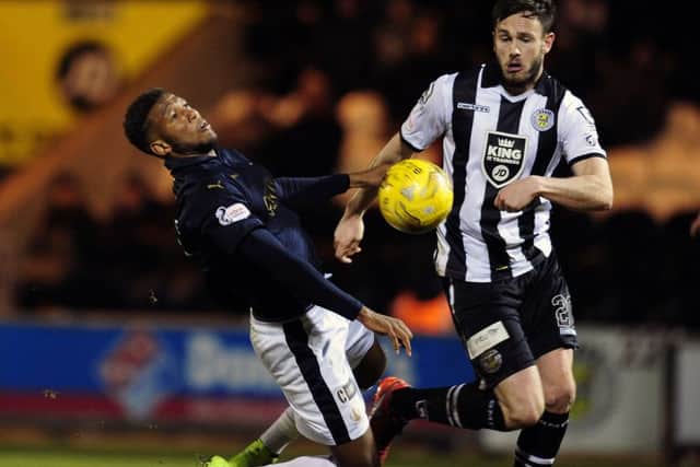 Keith Watson tussles with Falkirk's Myles Hippolyte. Picture: Michael Gillen