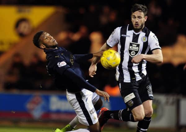 Keith Watson tussles with Falkirk's Myles Hippolyte. Picture: Michael Gillen