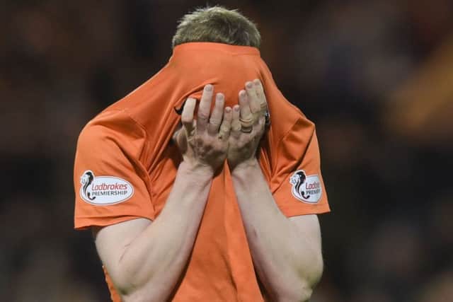 Dundee United left-back Paul Dixon is hit by the pain of relegation on the final whistle at Dens Par. Picture:Craig Williamson/SNS Group.