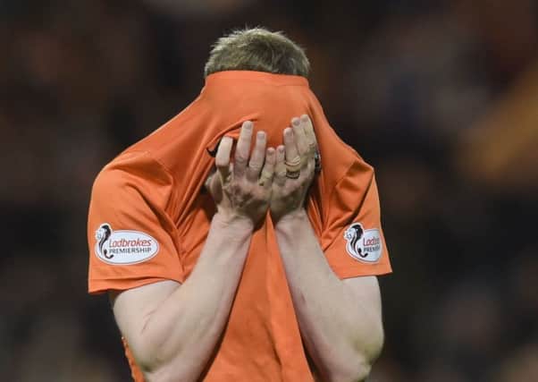 Dundee United left-back Paul Dixon is hit by the pain of relegation on the final whistle at Dens Par. Picture:Craig Williamson/SNS Group.