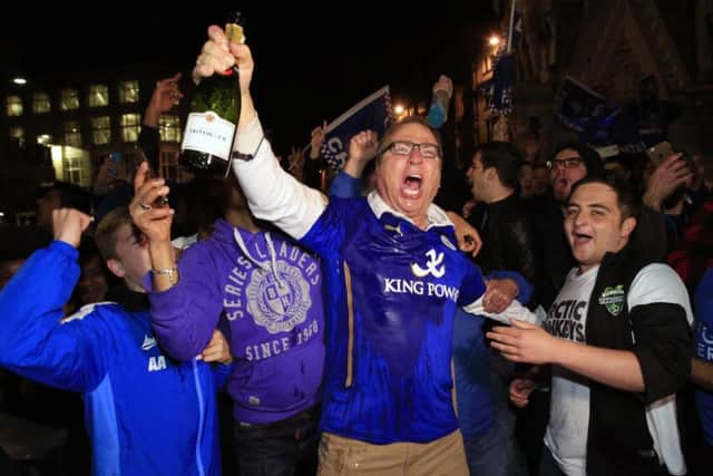 Foxes fans celebrate in central Leicester after Chelsea's draw with Spurs confirmed the title. Picture: PA