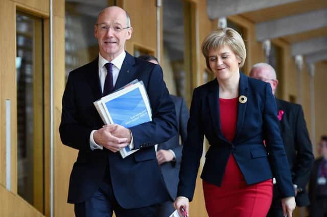 John Swinney, Scotlands finance secretary and Deputy First Minister Nicola Sturgeon, walk to Holyrood's main chamber. Picture: Getty