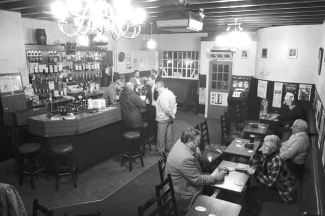 Punters men drinking in the Tolbooth Tavern pub in the Canongate Edinburgh, November 1988.