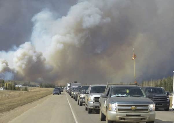 Panicked Fort McMurray residents were forced to run for their lives. Picture: AP