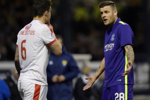 Raith's Kyle Benedictus (left) with Hibernian's Anthony Stokes during last night's match. Picture: SNS