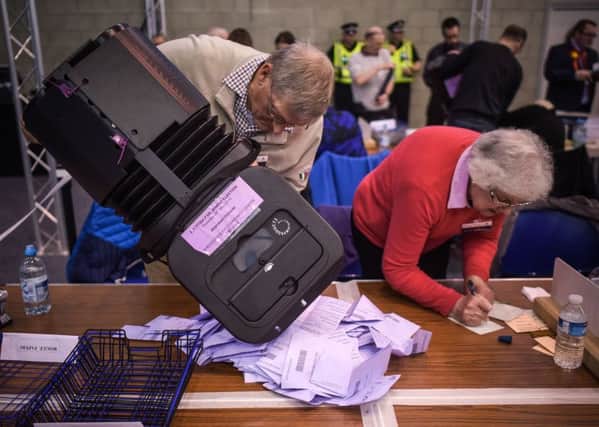 Counting Staff empty ballot papers at the Scottish Parliament Election count at Robert Gordon University in Aberdeen. Picture: SWNS