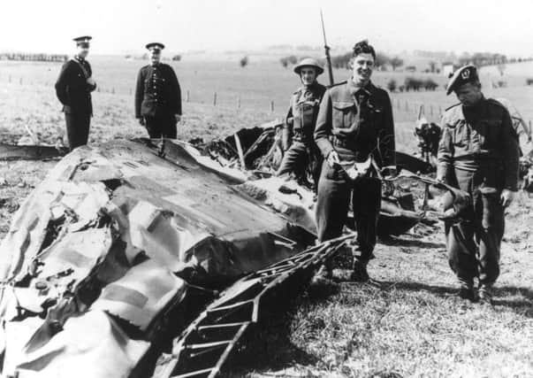 Soldiers and policemen in Eaglesham inspect the wreckage of the Messerschmitt ME-110 in which Nazi leader Rudolf Hess made his solo flight to Scotland in May 1941. Picture: Hulton Archive/Getty Images