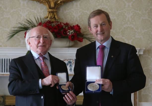 Newly elected Taoiseach Enda Kenny (right) receives the Seal of the Taoiseach and Seal of Government from President Michael D. Higgins. Picture: PA