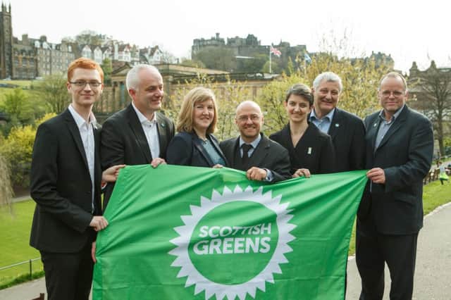 Green MSPs Ross Greer, Mark Ruskell, Alison Johnstone, leader Patrick Harvie, Maggie Chapman, John Finnie and Andy Wightman celebrate yesterday. Picture: Toby Williams