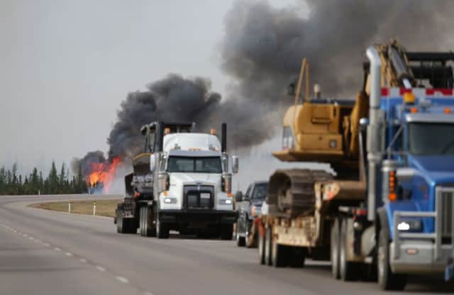 Flames rise off Highway 63 outside Fort McMurray. The town has been evacuated as the wildfire continues to burn in hot, dry weather. Picture: AFP/Getty