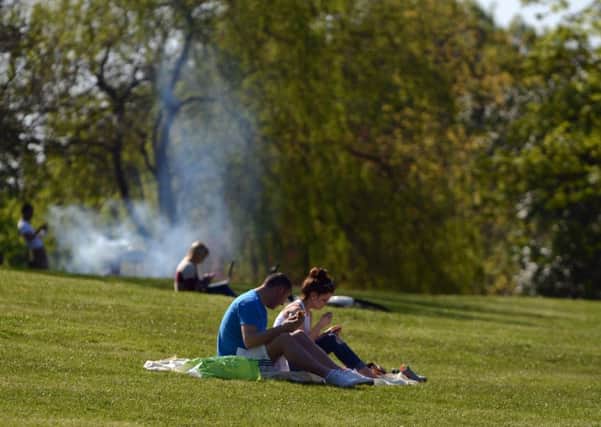 People enjoy summer weather in  Kelvingrove Park, Glasgow.
