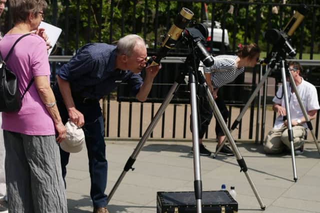 Members of the public look through telescopes to see the Transit of Mercury. Picture: PA